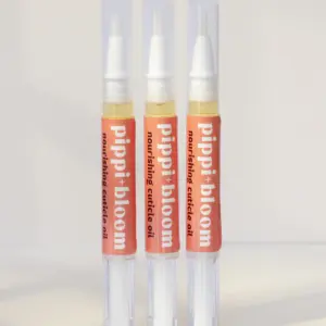 Three Pippi and Bloom cuticle oil brush pens standing side by side